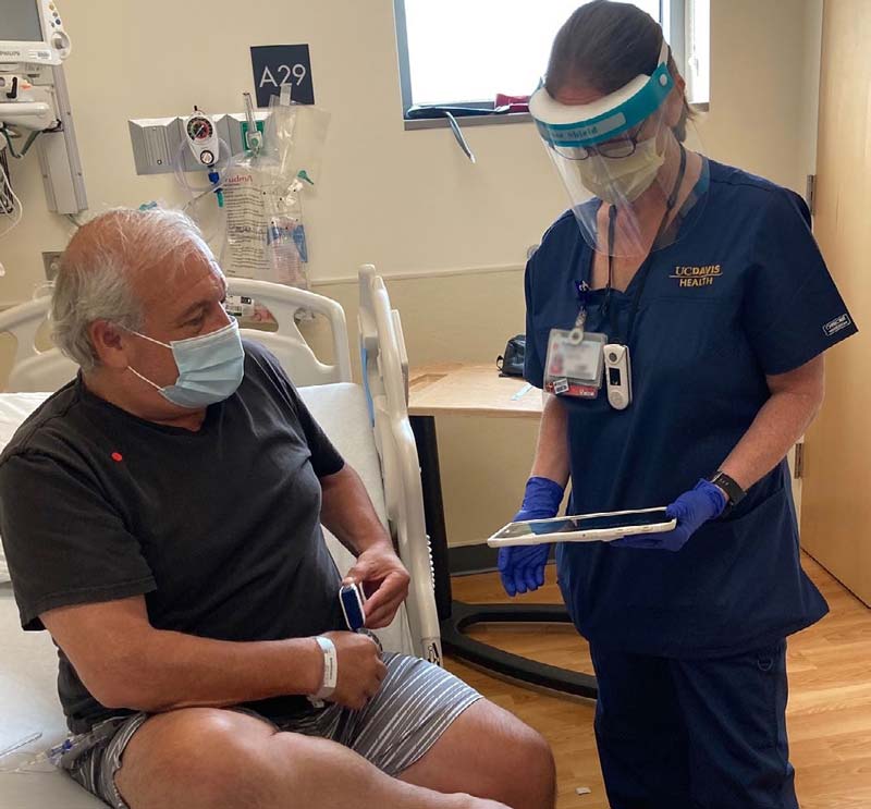 Cancer patient Peter Romero gets instructions about his pump care from infusion nurse Deborah Small.