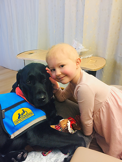 Peyton Cooley and UC Davis facility dog Huggie.