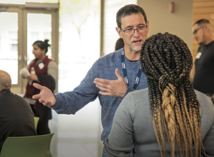 Marcio Malogolowkin, Pediatric Hematology and Oncology Division Chief, talks with event participant 