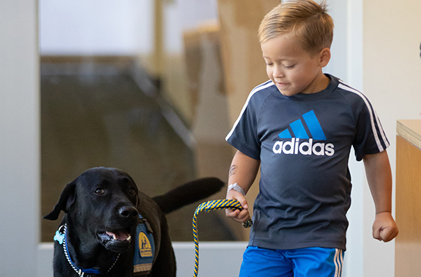 Fritz Stark and Huggie the UC Davis therapy dog trained to support kids with cancer.