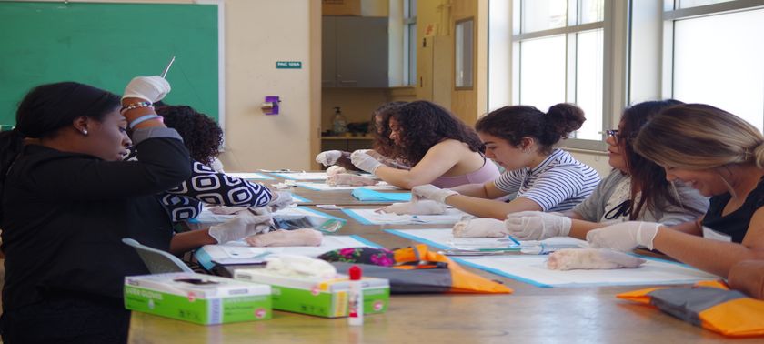 students practicing suturing skills